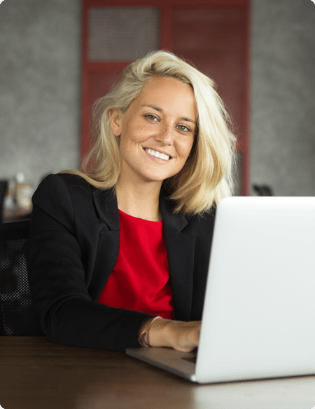 smiling-young-businesswoman-working-laptop 1-2 smiling-young-businesswoman-working-laptop 1-2